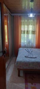 a bedroom with a bed and a window at Niku HomeStay in Berat