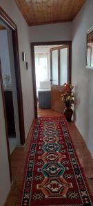 a hallway with a rug on the floor in a room at Niku HomeStay in Berat