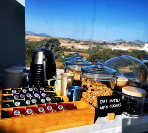 a table topped with jars of food and other foods at Avra Pahainas in Pachaina