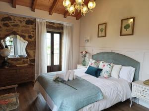 a bedroom with a large bed and a mirror at A Solaina da Bouza in Cambados