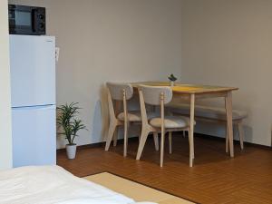 a kitchen with a table and chairs and a refrigerator at Private Villa Tofukuji in Kyoto