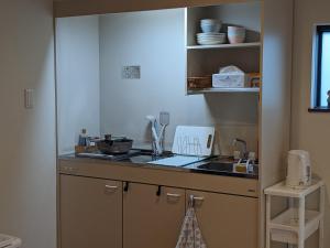 a kitchen with a sink and a counter top at Private Villa Tofukuji in Kyoto
