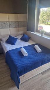 Ένα ή περισσότερα κρεβάτια σε δωμάτιο στο Błękitne Wierchy