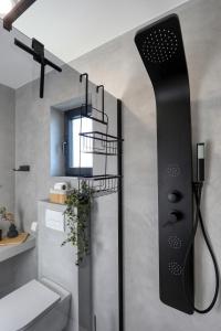 a shower in a bathroom with a black shower head at Villa Cvit Mediterana with heated pool in Knežević