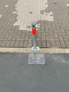 a fire hydrant with a sign on the street at North Kelvin Guest House in Glasgow