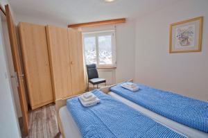Ένα ή περισσότερα κρεβάτια σε δωμάτιο στο Haus Bodmen C, Apartment Anemone