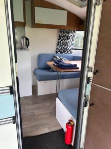 a tiny house with a table and a blue couch at The blue lady in Sleen