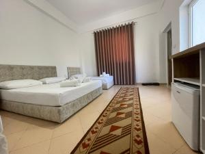 a bedroom with a bed and a rug in a room at Villa Deart Berat in Berat