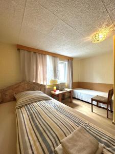 a bedroom with a large bed and a window at Kimbab Restaurant und Pension in Ruhla