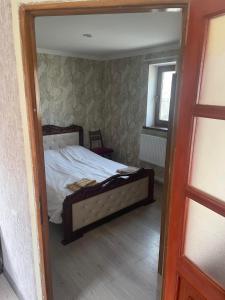 a bedroom with a bed and a mirror at GuestHouse in Gyumri +6 photos