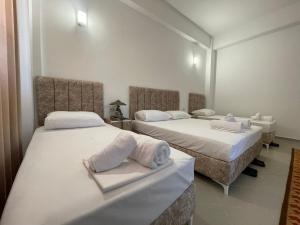 a room with two beds with towels on them at Villa Deart Berat in Berat