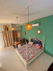 a bedroom with a bed and a living room at Plage Ewell in Cotonou