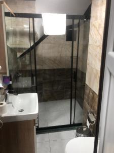a bathroom with a shower and a sink at LAOS OTEL in Istanbul