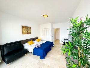 a bedroom with a bed and a couch at Spectacular Sea Views Torremolinos in Torremolinos
