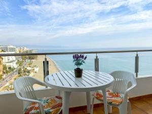 a white table and chairs on a balcony with the ocean at Spectacular Sea Views Torremolinos in Torremolinos