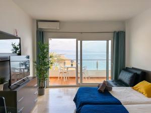 a bedroom with a bed and a view of the ocean at Spectacular Sea Views Torremolinos in Torremolinos
