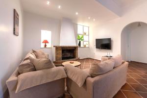a living room with a couch and a fireplace at Memories Gytheio in Gythio