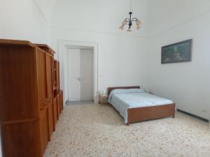 a bedroom with a bed and a dresser at Casa Scottodiuccio in Procida