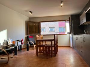 una cucina con tavolo e sedie in una stanza di La Vall Apartaments Loft a Sant Llorenç de Morunys
