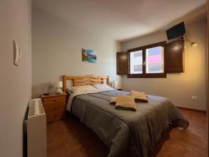 a bedroom with a bed with two towels on it at La Vall Apartaments Loft in Sant Llorenç de Morunys