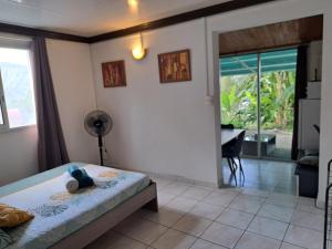 a bedroom with a bed and a desk and a window at Studio avec superbe vue in Entre-Deux