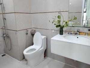a bathroom with a toilet and a sink at Happiest Homestay 1 - Manor Crown Hue in Hue