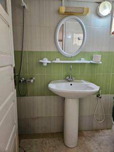 a bathroom with a sink and a mirror at Hadhri Appartement in Tozeur +26 photos