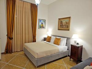 a bedroom with a bed and a couch at Vatican Prestige - Meospiti Cesare Exclusive in Rome