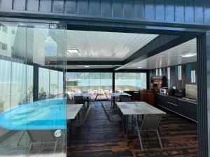 a restaurant with tables and chairs and a large window at CASA DAVID in Dubova