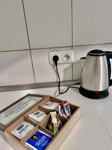 a kitchen counter with a box of food and a blender at Moderne ruhige Wohnung Bochum angebunden in Bochum +21 photos