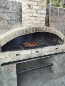 a brick oven with food cooking inside of it at GuestHouse ED&ER near airport in Geghanist