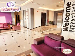 a lobby of a salon with a purple couch at Salsa Resort Langkawi By Casa Loma in Pantai Cenang