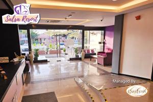 a lobby with a salon repair sign on the wall at Salsa Resort Langkawi By Casa Loma in Pantai Cenang