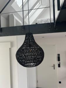 a black chandelier hanging from a ceiling in a room at Suite One Löwengrube in Munich