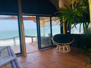 a room with a table and a view of the ocean at Bara Beach Home in Galle