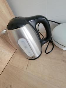 a black and silver tea kettle sitting on a table at Chambres spacieuses hyper centre in Saint-Étienne