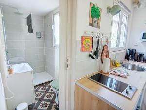 a small bathroom with a sink and a shower at Les Glycines Oloron in Oloron-Sainte-Marie +26 photos