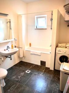 a bathroom with a sink and a washing machine at Apartments Casa Toni Dubrovnik in Dubrovnik