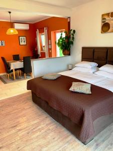 a bedroom with a large bed and a dining room at Apartments Casa Toni Dubrovnik in Dubrovnik