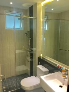 a bathroom with a toilet and a shower and a sink at LUXURY 3BR Penthouse I The Shore Hotel & Residence I Seaview I Poolview I 6-9Pax in Malacca