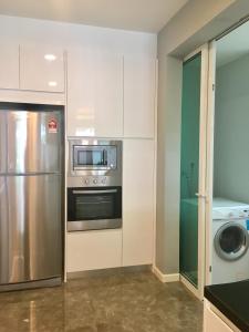 a kitchen with a stainless steel refrigerator and a microwave at LUXURY 3BR Penthouse I The Shore Hotel & Residence I Seaview I Poolview I 6-9Pax in Malacca