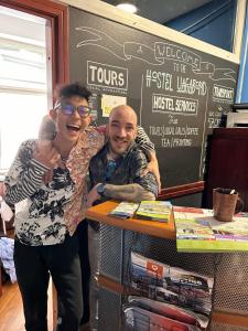 a man and a woman standing next to a table at Hostel Vagabond in Sarajevo