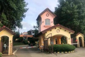 a pink and white house with a clock at tadzmahal home in Pagadian