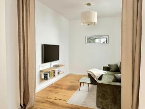 TV a/nebo společenská místnost v ubytování Refugium 29 - Apartment im Ahrtal