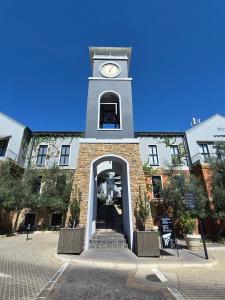 un edificio con una torre de reloj encima en Am Weinberg Estate - The Presidential Villa - A Sanctuary of Luxury and Elegance, en Windhoek