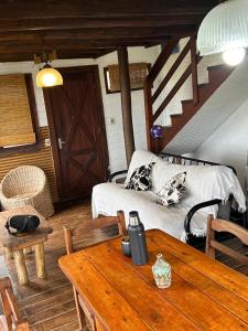 a living room with a table and a couch at Oikos in Punta Del Diablo