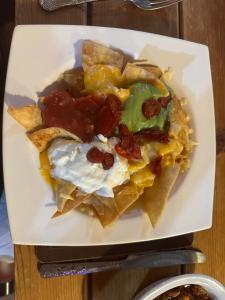 a white plate of food with chips and eggs at Cross Keys Hotel Chatteris in Chatteris