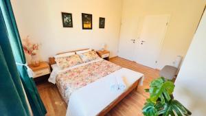 a small bedroom with a bed and a plant at Beach Apartment x2 Bedrooms w Sea View & 2x En-Suites in Šibenik
