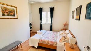 a small bedroom with a bed and a window at Beach Apartment x2 Bedrooms w Sea View & 2x En-Suites in Šibenik