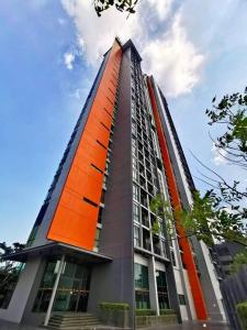 a tall building with an orange at Infinity Pool at Pattaya Posh in North Pattaya